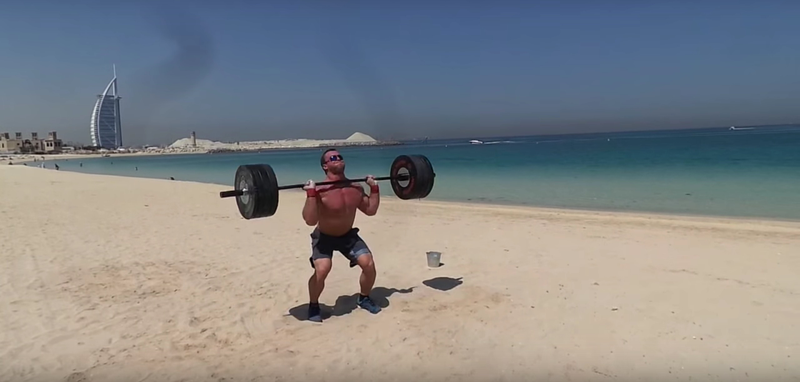 Dmitry Klokov trains on the beach in Duba. Image via Youtube